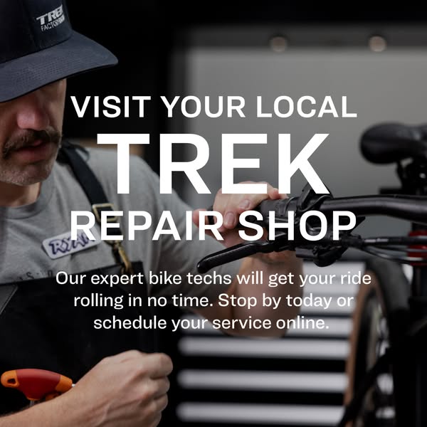 This ad is for Trek Bicycle repair shops. The ad features a close-up of a repair technician working on a bicycle, with t