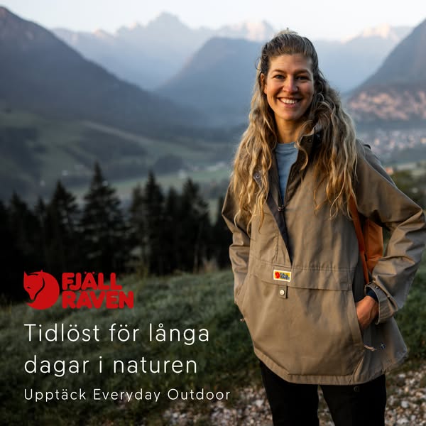 This ad features a smiling woman wearing a Fjallraven anorak jacket in an outdoor setting, with mountains in the backgro