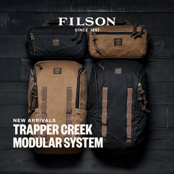This ad showcases Filson's Trapper Creek Modular System, highlighting the new arrivals in both black and tan colors.