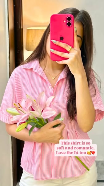 This image ad highlights a pink-striped shirt, emphasizing its softness, romantic appeal, and flattering fit through a c