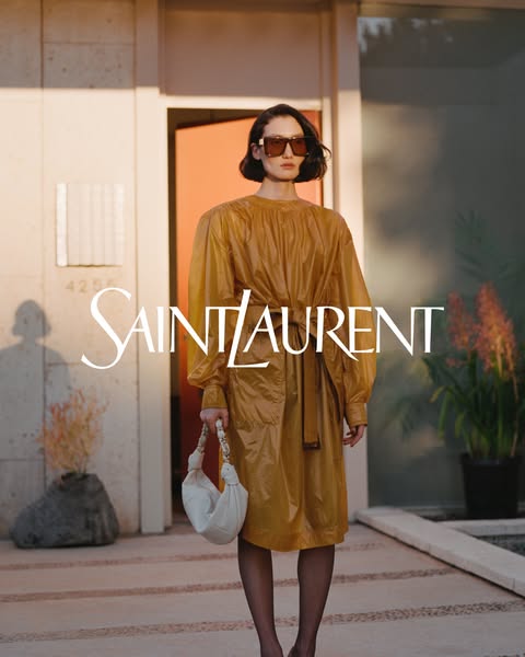 This ad showcases the Saint Laurent brand with a focus on high fashion and luxury. It features a woman in a stylish sett