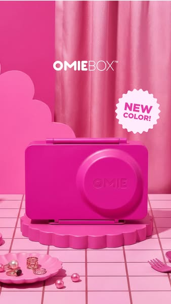 This ad features OmieBox lunchbox in a bright, monochromatic pink setting. The ad focuses on a new color of the product 