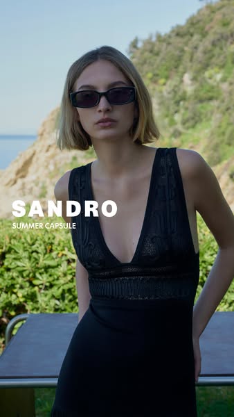 This ad for Sandro features a model wearing a black dress and sunglasses from their Summer Capsule collection. The ad is