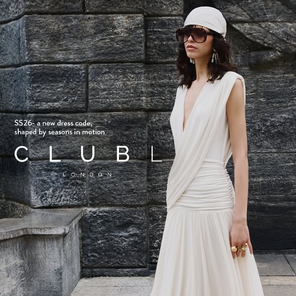 This image ad for Club L London showcases a woman wearing a white dress. The text overlay notes that it is a new dress c