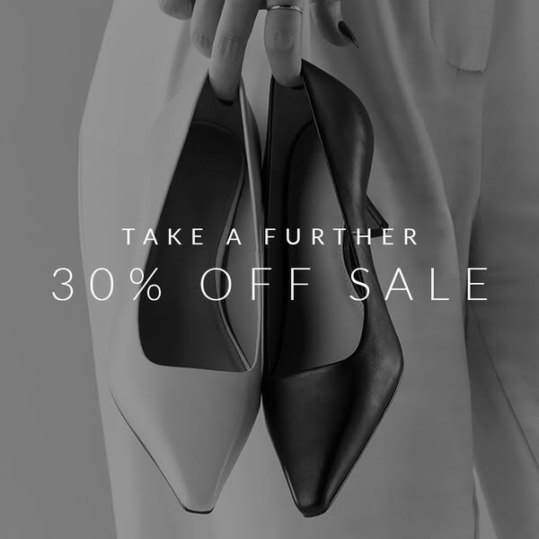 This image ad showcases women's heels on sale. The focal point is two high heels of different colors being held up. 