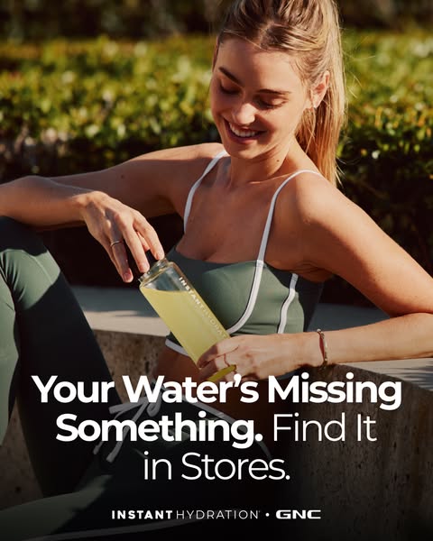 This ad promotes instant hydration by GNC. The ad features a smiling woman in athletic wear preparing a clear bottle fil