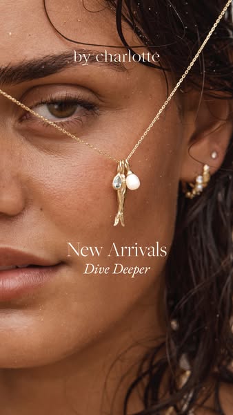 The advertisement showcases a close-up shot of a woman's face adorned with a gold necklace from By Charlotte's n
