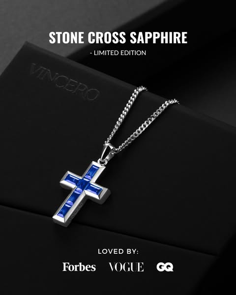 This ad features a close-up of the Vincero Stone Cross Sapphire necklace on a black surface, subtly showcasing the brand