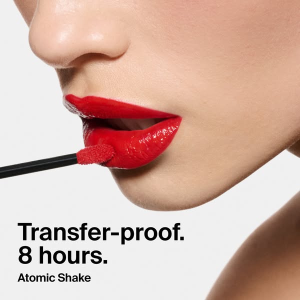 An extreme close up of a person applying vibrant red lip product using a doe foot applicator. Features transfer-proof me