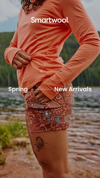 This image showcases Smartwool apparel in a natural outdoor setting, emphasizing their spring collection with a focus on