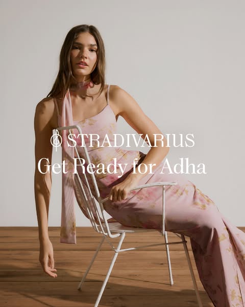 An image ad shows a model seated on a white chair, wearing a dress and scarf that match the floral color scheme.