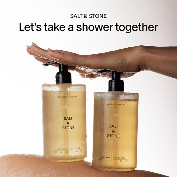 This ad for Salt & Stone body wash features two product bottles being held under running water. The ad features the 
