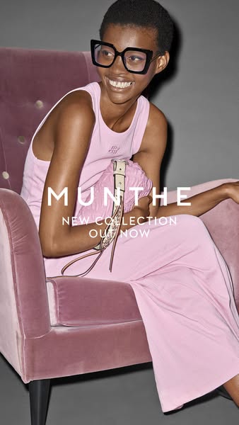 This image ad showcases a woman sitting on a chair wearing a pink outfit and holding a handbag to promote the brand'
