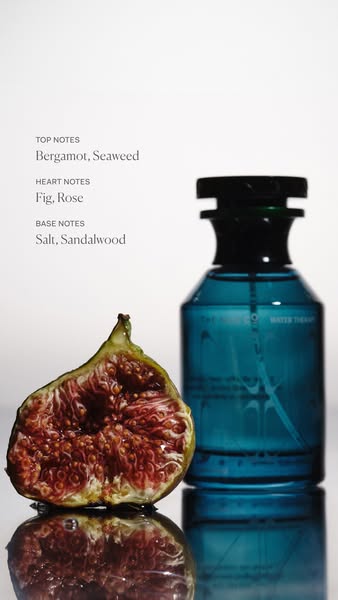 This ad showcases a blue glass bottle of Water Therapy fragrance. The ad highlights the fragrance's top, heart, and 