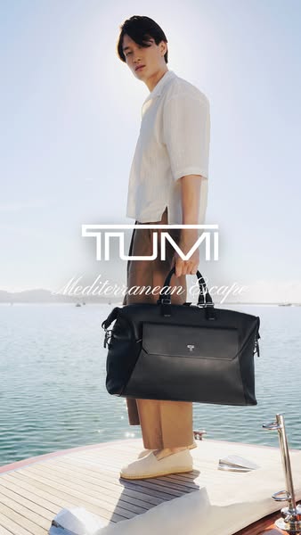 An ad for TUMI luggage highlighting their Mediterranean Escape bag. A man is seen standing on a boat holding the TUMI ba