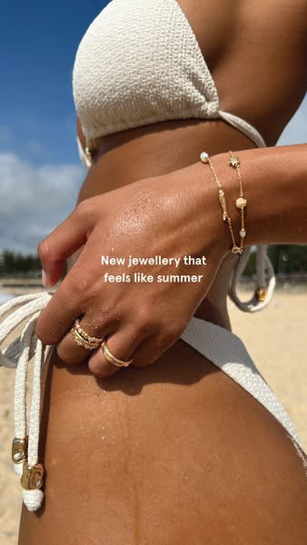 This ad promotes jewelry that is designed to evoke the feeling of summer. It features close-up shot of jewelry on a woma