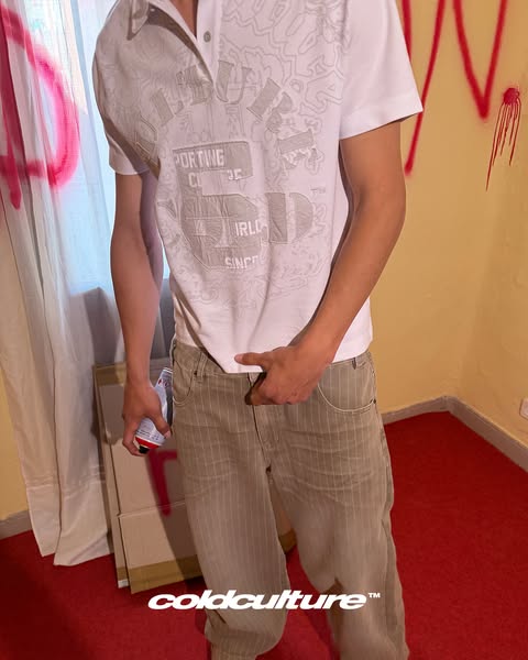 This ad features a person holding a can of an alcoholic beverage, wearing a white shirt and khaki striped pants. The pho