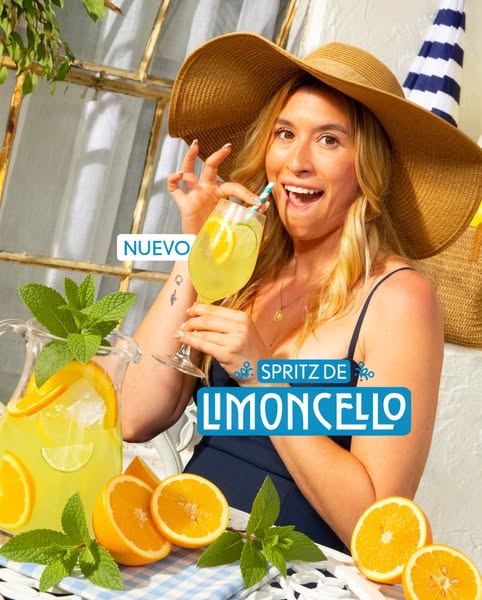 This ad showcases a woman enjoying a Spritz de Limoncello, emphasizing its refreshing qualities for summer. The visual e