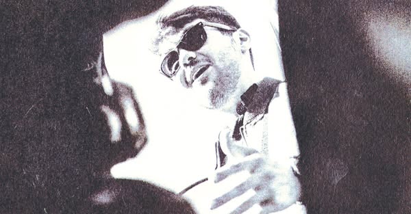 This black-and-white image ad features an image of George Michael, perhaps taken from the music video for his song, '