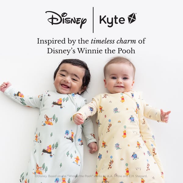 An image ad featuring two babies wearing Disney Winnie the Pooh-themed Kyte Baby sleep sacks. The ad aims to highlight t