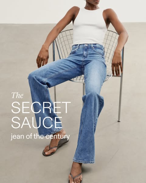 An image ad showcasing 'The SECRET SAUCE jean of the century' worn by a model in a casual, bright setting.