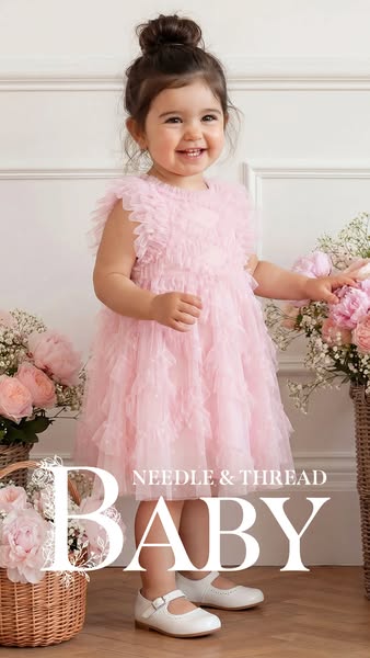 This is an advertisement for Needle & Thread Baby. It features a toddler in a pink dress surrounded by pink flowers.