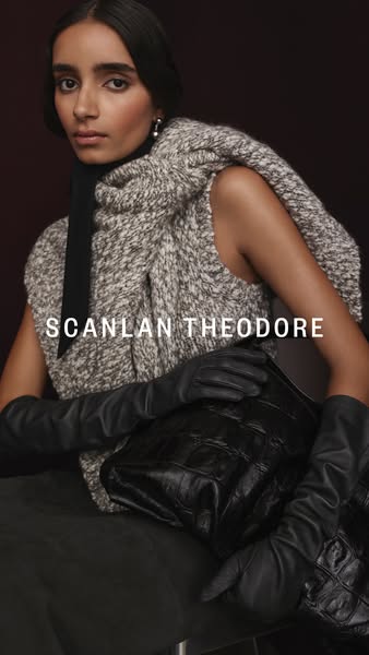 This ad showcases a woman wearing Scanlan Theodore clothing, including a wool vest, black top, black gloves and holding 