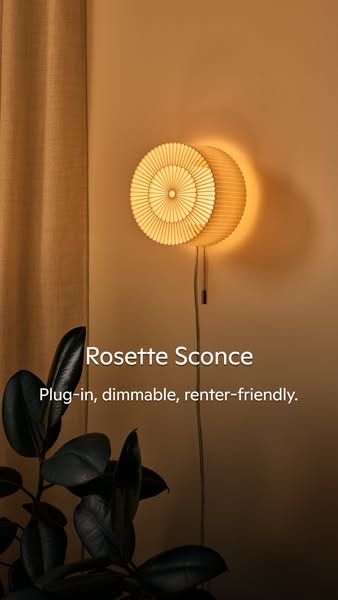 This image ad features a plug-in Rosette Sconce, emphasizing its dimmable and renter-friendly features.
