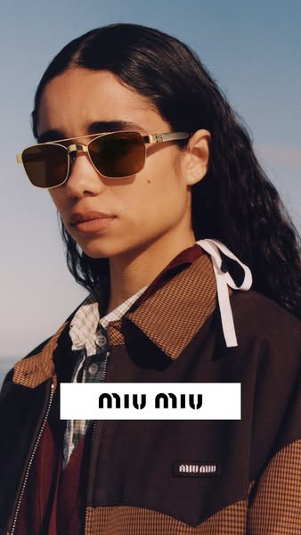 This image ad features a woman wearing Miu Miu sunglasses and a jacket. The ad's focus is on luxury fashion and the 