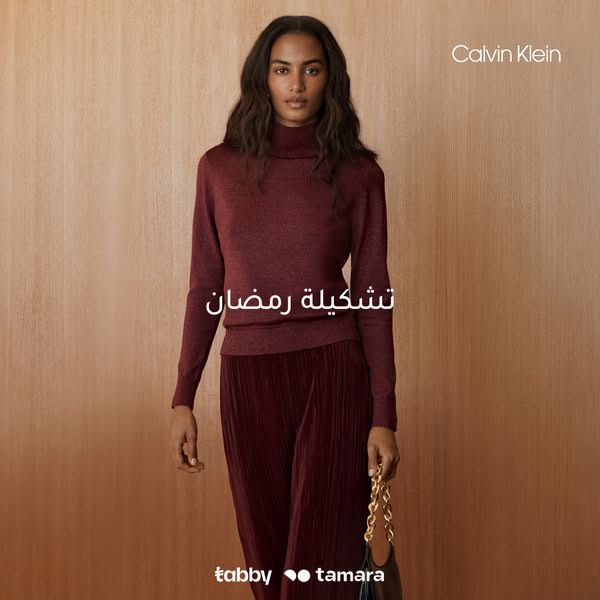 A Calvin Klein ad featuring a model wearing a matching sweater and skirt. The ad also contains text that translates to &
