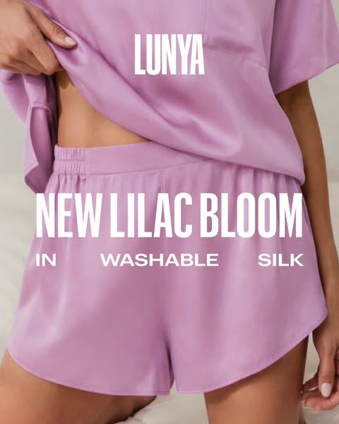 This image ad features a close up of a person wearing a Lunya lilac pajama set. The ad highlights the new color as well 