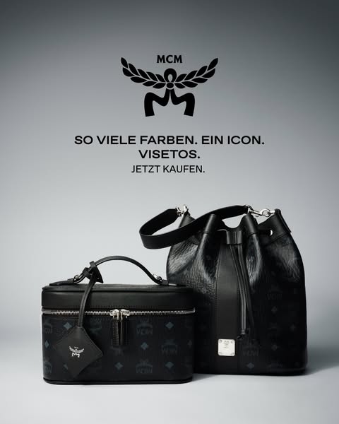An ad featuring a black MCM bucket bag and a small black MCM case bag. The ad features the brand's logo at the top a