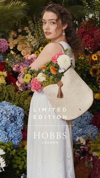 This ad features a person standing among flowers and holding a straw bag from Hobbs London. The ad reads "Limited E