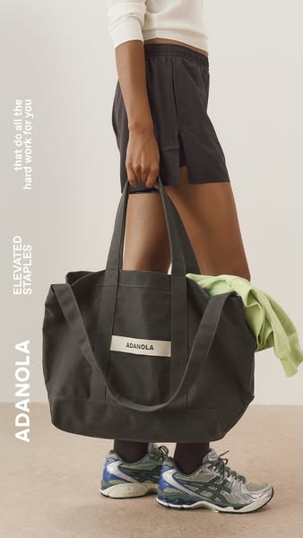 This ad features a model carrying a large tote bag from Adanola, promoting the brand's elevated staples.