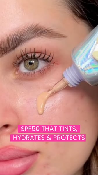 A close-up shot of a woman applying tinted SPF. The ad emphasizes the product's multi-functional benefits: SPF50 pro