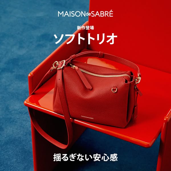 This ad features a luxury red handbag from Maison de Sabre, positioned on a matching red chair against a blue background