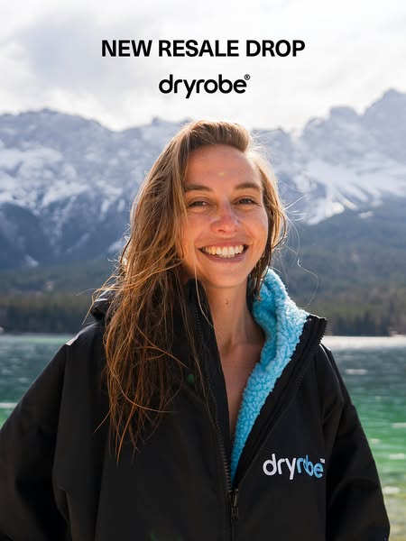 This ad features a woman modeling a black dryrobe® in front of a mountain and lake background. The ad announces a "