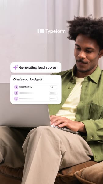 The ad shows a man working on a laptop while sitting on a couch. Overlaid on the screen is a Typeform that asks 'Wha