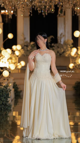 An image ad of a woman wearing a floor-length white gown. The text indicates the product number.