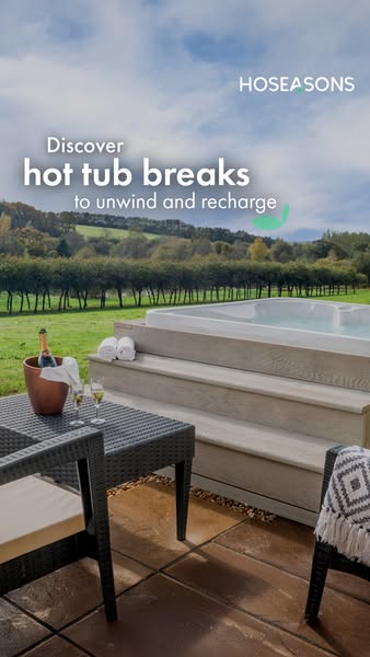 This image ad showcases a luxury hot tub getaway provided by Hoseasons. The scene features a built-in hot tub, outdoor f
