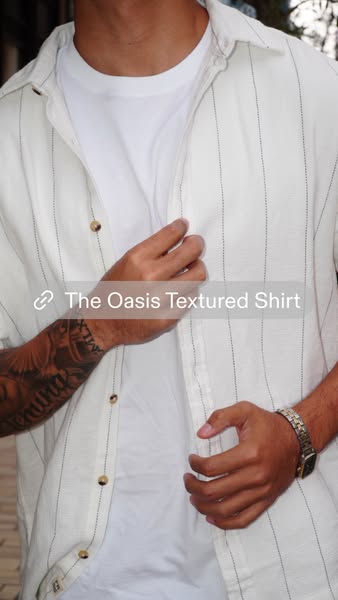 A close-up shot of a man wearing a textured, striped shirt. The ad features a link to the shirt.
