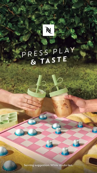 This ad showcases Nespresso coffee pods being used as game pieces on a pink and white checkerboard. Two iced coffees are