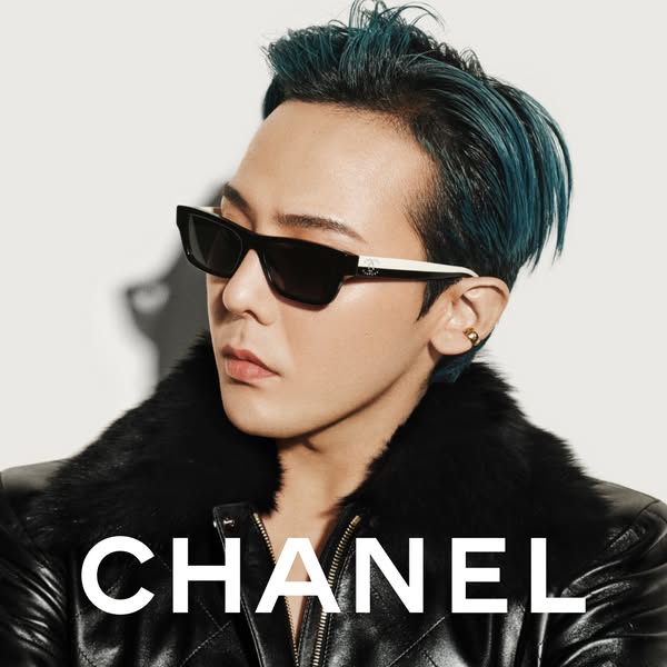This image ad features a close-up of a celebrity wearing Chanel sunglasses and a leather jacket, set against a neutral b