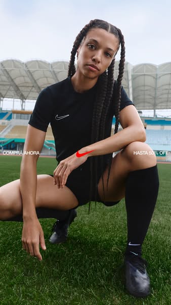 This ad features a female soccer player with a digitally drawn red Nike swoosh on her wrist, accompanied by Spanish text