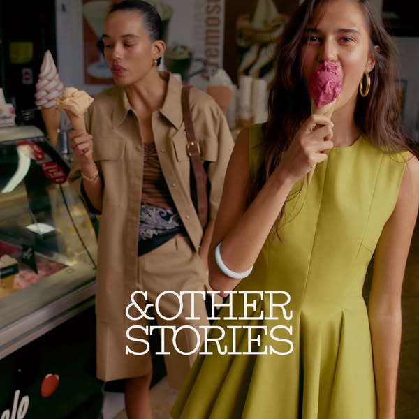 This ad features two stylishly dressed women enjoying ice cream, promoting the & Other Stories brand. The setting su