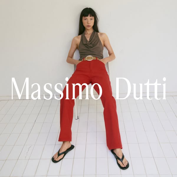 This ad features a model wearing a Massimo Dutti top and red pants while sitting on a stool. The ad is designed to showc