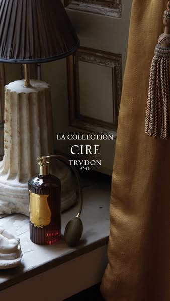This ad features a TRVDON Cire Collection perfume bottle alongside interior decoration, positioning it as a luxury home 