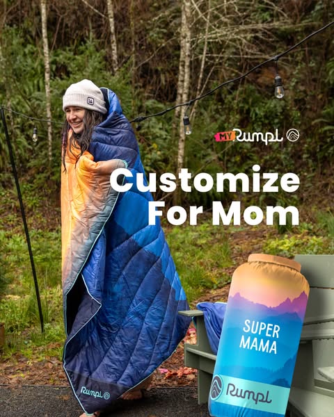 This image ad for Rumpl promotes customizable blankets for mothers. It features a woman wrapped in a Rumpl blanket outdo