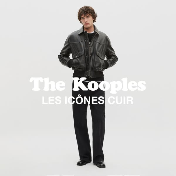 This ad features a full-body shot of a male model in an all-black outfit, showcasing a leather jacket from The Kooples&#