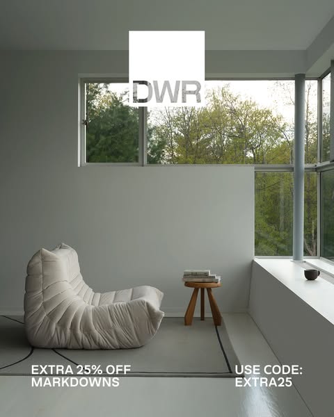 This ad showcases a stylish, modern living room featuring the brand's furniture, specifically a Togo chair and a sma